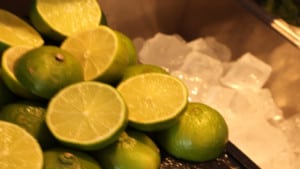 cut limes and ice cubes in tray